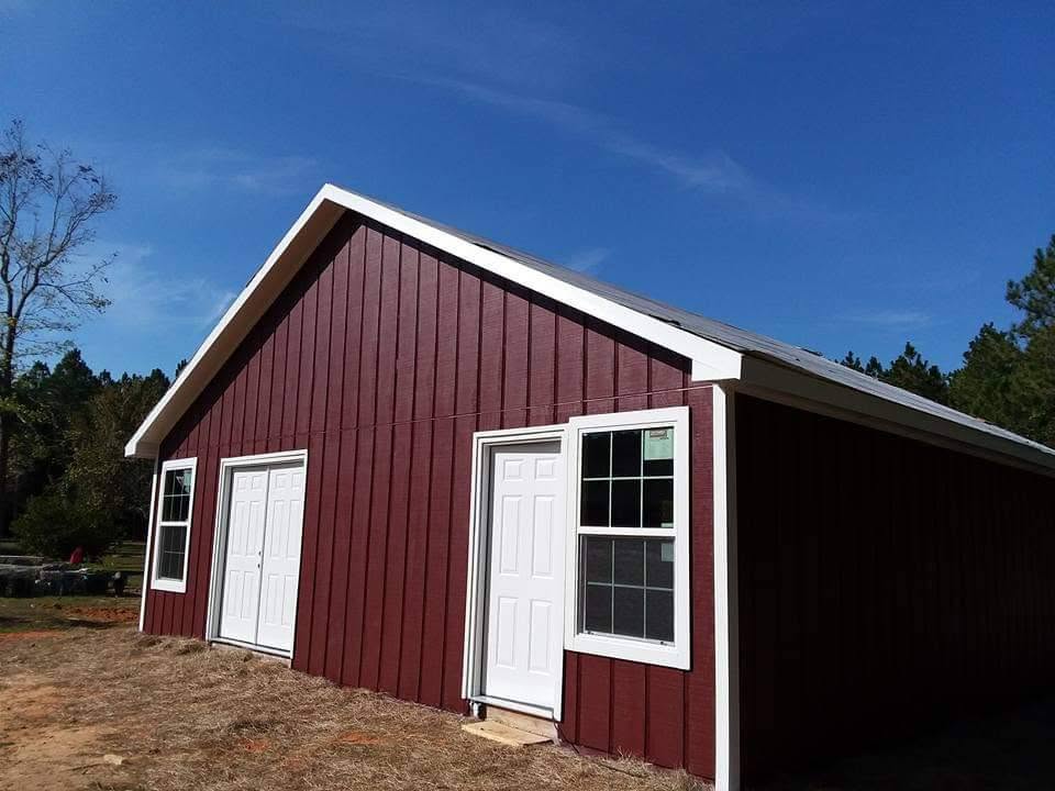 Deep red board-and-batten barn with white trim