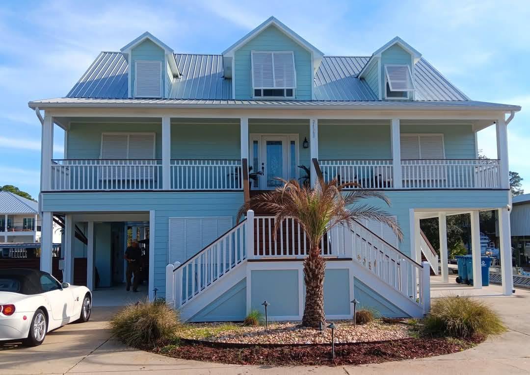 Two-story light blue home — after