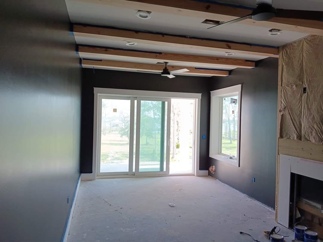 Dark interior with exposed wood beams mid-project