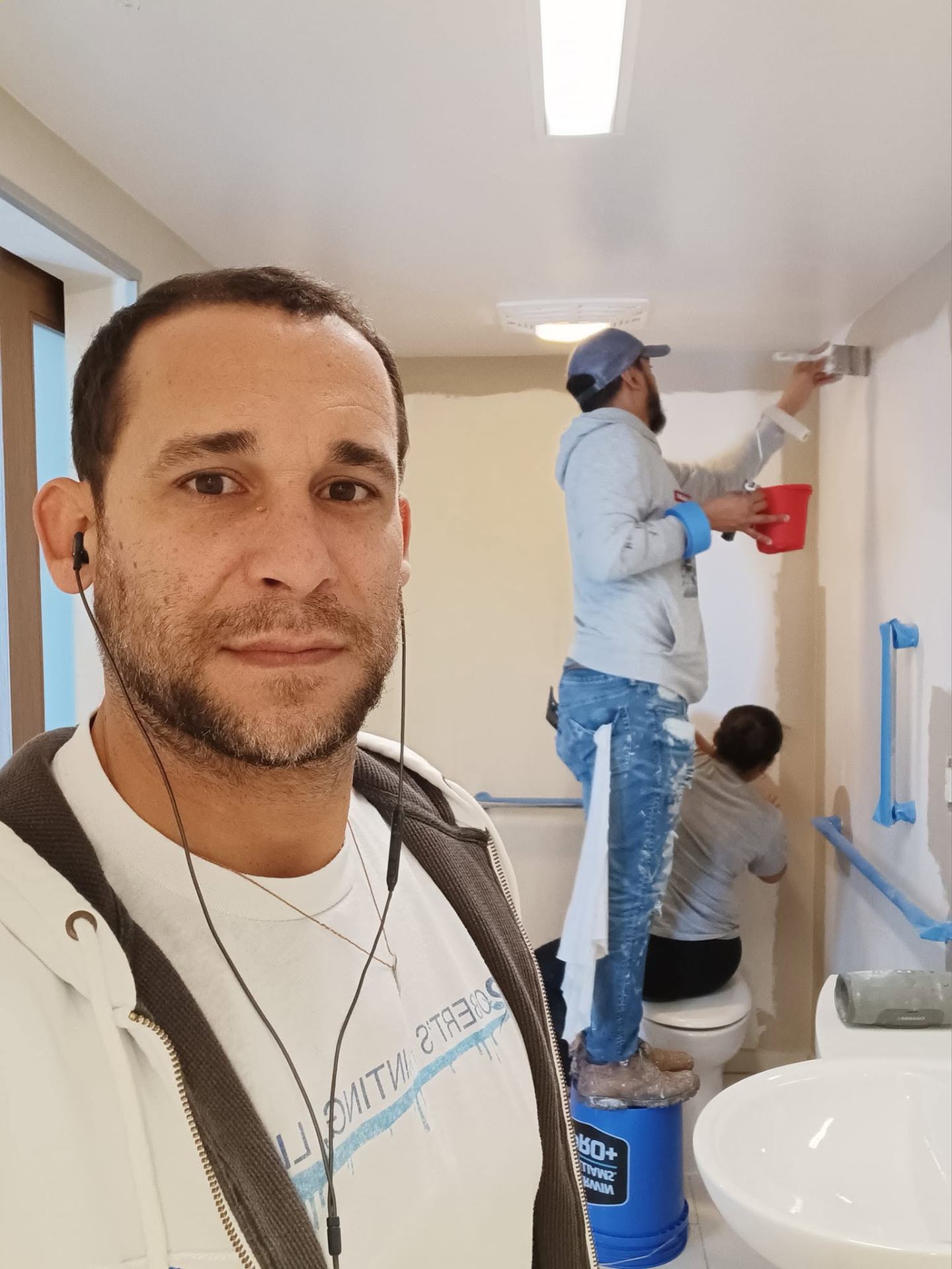 Roberto and crew repainting a bathroom interior